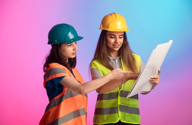 Female construction engineers working together discussing project plan colorful background 114579 17651